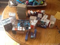 Multiple small boxes of automotive headlights and bulbs stacked on a table.