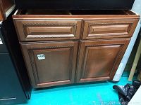 Full front view of bathroom vanity cabinet showing two doors and two top drawer sections (left one functional, right one false)