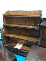 Front angle view of the wooden dresser hutch showing open shelves and drawer base