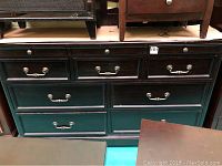 Front view of dark wood buffet with seven drawers and metal pull handles