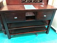 Full frontal view of the wood sideboard showing two drawers with metal handles, central open cubby, and bottom slatted shelves.