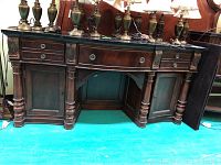 Front view showing entire buffet with stone top and carved accents