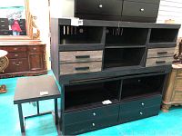 Photo showing the full credenza style TV stand and Ashley metal base side table side by side.