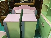 Side view of the child's chest and cubby showing pink tops, green fronts and purple scalloped edges