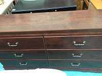 Top view of dresser showing six drawers with metal handles and wood grain finish
