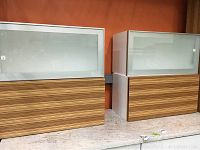 Two cabinets placed side-by-side showing the mixed wood and frosted glass design.