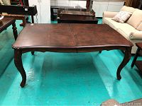 Full view of rectangular wooden table in showroom