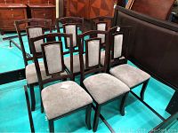 Six Ashley Furniture dining chairs arranged in two rows, showing full frontal view of both upholstery and wood frame.