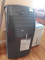 Front view of black LG portable air conditioner showing control panel, LED display and logo