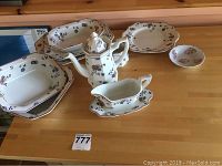 Adams English China consisting of 9 pieces including dishes, plates, teapot, gravy boat, and small bowl, displayed on a wooden countertop.