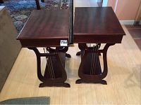 Top view showing two wooden side tables with rectangular tops and lyre-shaped sides with metal rods.