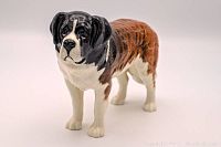 Front view of Beswick St. Bernard dog figurine showing detailed face and front legs.