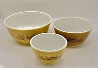 Three vintage Pyrex mixing bowls in Forest Fancies pattern, showing size differences and pattern colors.