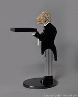 Side view of resin butler tray table showing full figure, black circular base, and removable tray.