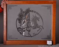 Full view of the vintage frosted glass window with etched Pegasus design and decorative corner etching in a wooden frame.