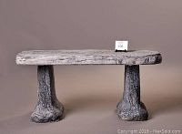 Front view of the concrete bench showing separate legs and textured surface