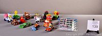 Collection of diecast character toy cars including Disney, Thomas & Friends, arranged to show variety.