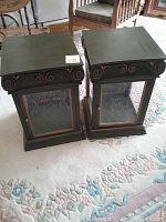 Pair of green-painted wood end tables shown side by side on carpeted floor, square tops with decorative edges.