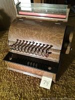 Full view of the vintage National Cash Register with wooden curved front and multiple input keys.