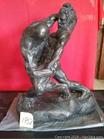 Front view of sculpture showing two wrestlers grappling