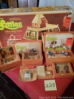 All boxed items displayed together: dollhouse, furniture sets, doll packs.