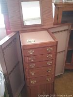 Full view of open cabinet showing 5 drawers, side doors with hooks, and mirror on top