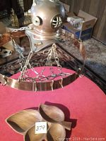 Overview of pot rack suspended above red table with wooden serving platter beneath