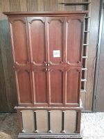 Closed front view of full wood cabinet