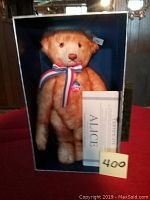 Front view of the Steiff Alice Growler bear inside its original blue box, with certificate and number card showing 400.