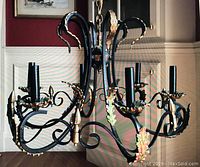 Full front view of the 6-arm wrought iron chandelier with gold acanthus leaf details.
