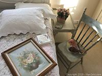 Overall lot on bed and beside table, showing quilt, framed floral art, card, chair, and rose bouquet