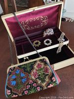 Photo showing the Isabella Fiore beaded purse with floral beadwork, vintage jewelry box, and assorted jewelry pieces organized inside the box.