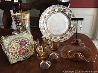 The full set including Delill vintage purse with floral embroidery, Coronation plate with colorful garland border, amber glassware items, etched glass vase, artisan earrings with vintage beads, and cordial glasses.