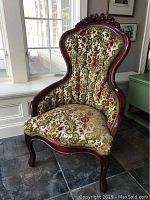 Full view of Victorian-style side chair featuring jewel tone floral cut velvet upholstery and dark wood frame with carved details. Chair dimensions and minor upholstery discoloration visible.