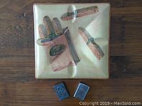 Top-down view of square ceramic ashtray with retro smoking accessory illustration