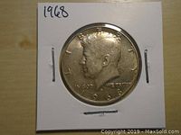 Obverse side of 1968 US Kennedy Half Dollar showing John F. Kennedy profile with inscriptions and date.