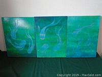 Full view of the three paintings showing the fish and aquatic backgrounds.