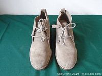 Top view of the pair of taupe suede lace-up shoes showing the front and laces.