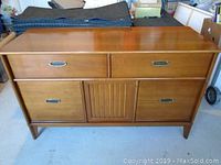 Front view of the wooden hutch with four drawers and a central cabinet door, showing overall design and condition.