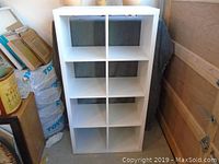 Front view of white IKEA cube storage unit showing 8 open cubes.