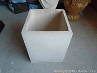Front side view of square cement planter showing size and shape.