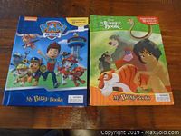 Two My Busy Books side by side on a table: Paw Patrol and The Jungle Book editions, showing front covers