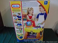 Front of sealed box for Little Tikes Makin' Real Ice Cream playset showing children playing with the ice cream set and details of the toy.