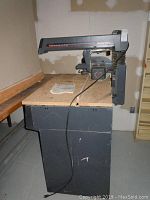 Full view of Sears Craftsman 10-inch radial saw on cabinet.