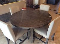 Overview of round dining table with four chairs arranged around it
