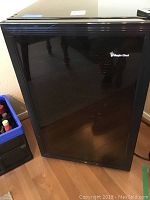 Closed black Magic Chef wine refrigerator with glass front door
