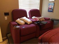 Front view of two red cloth electric theater recliner seats side by side