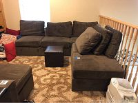 Modular sectional assembled in L-shape showing three seat modules and chaise with cushions and ottoman in front