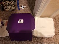 Purple Silk'n branded storage box open showing interior and white Serious Skincare soft case with zipper closure.