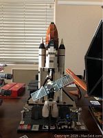 Front view of assembled shuttle, display stand, and solar panel satellite
